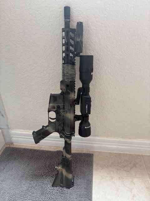 300 BO with NV scope, binary trigger, laser.